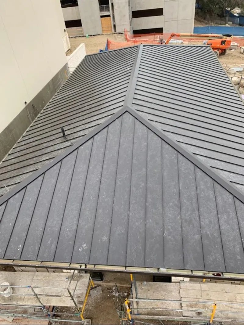 Commercial metal roof construction with crane equipment in Terrace Heights