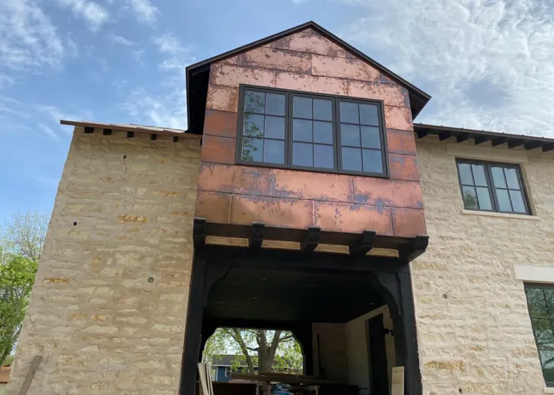 Copper metal panel facade on a stone building for Skylight Installation in Terrace Heights